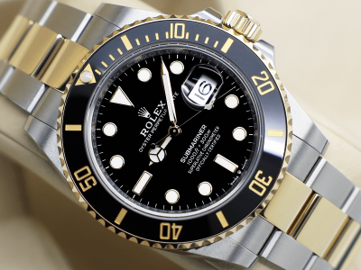 Rolex Submariner 18ct yellow gold and stainless steel 41mm watch with a black dial and black ceramic bezel